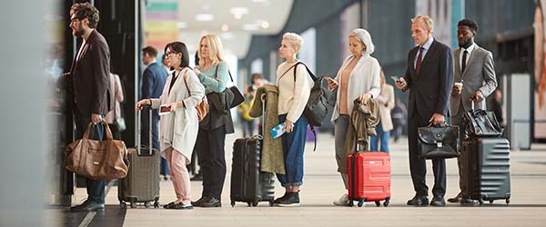 Horizontal,Side,View,Shot,Of,People,Standing,In,Queue,With